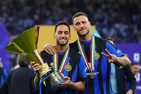 Hakan Calhanoglu and Mirko Arnautovic celebrate Serie A victory
